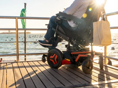 person-in-wheelchair-on-coastal-pier-at-sunset-2026-03-17-21-42-25-utc